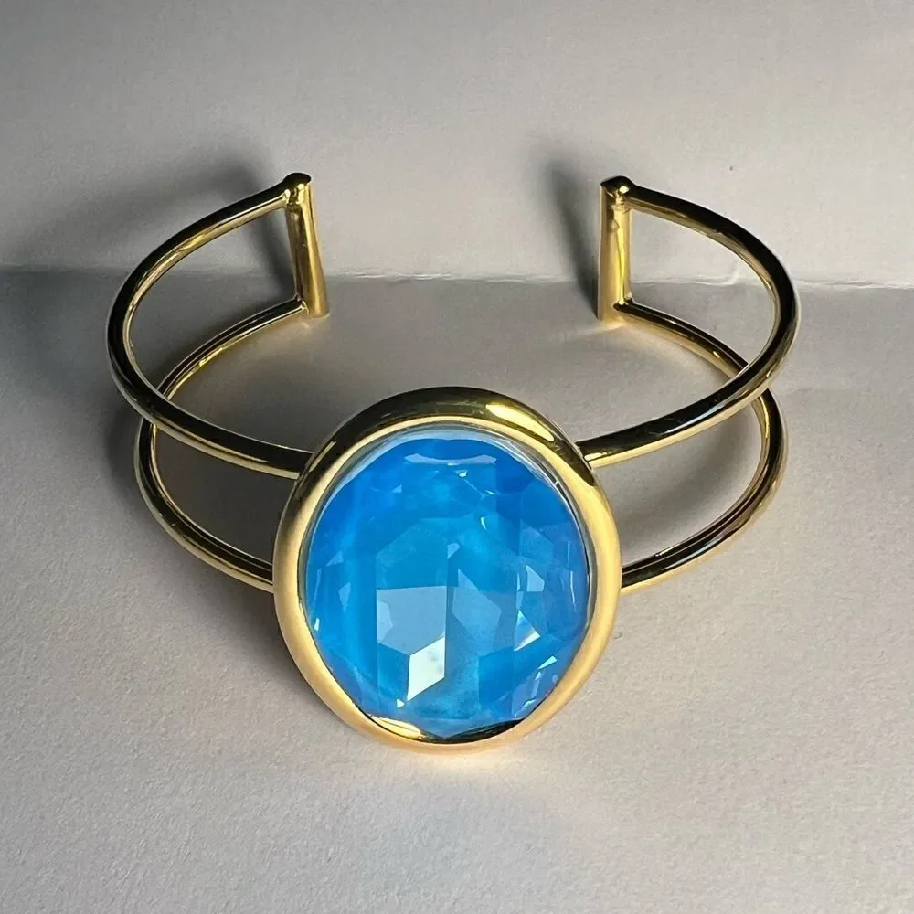A Gold Handcrafted bracelet with large oval blue Swarovski crystal